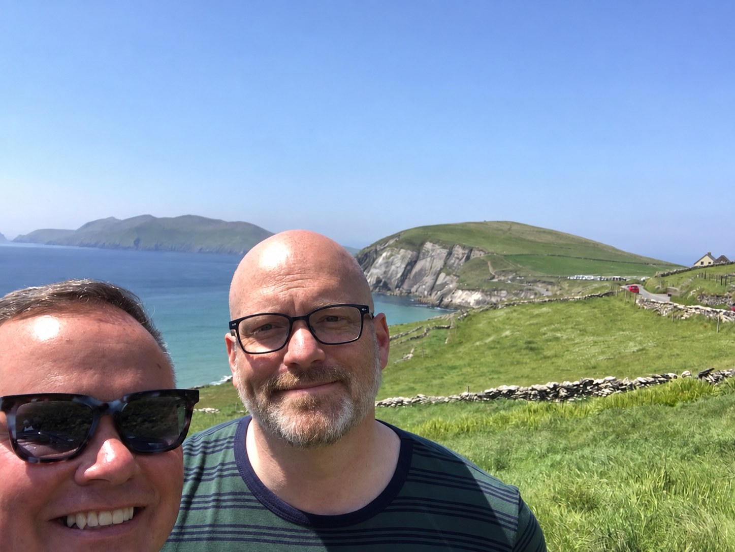 Faust and Glen smiling together on the coast of Ireland