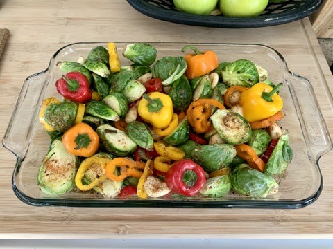 Colorful peppers and vegetables in a clear baking dish