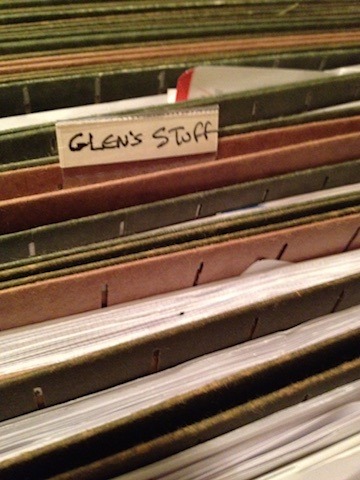 Files and folders with a handwritten label reading Glen's Stuff