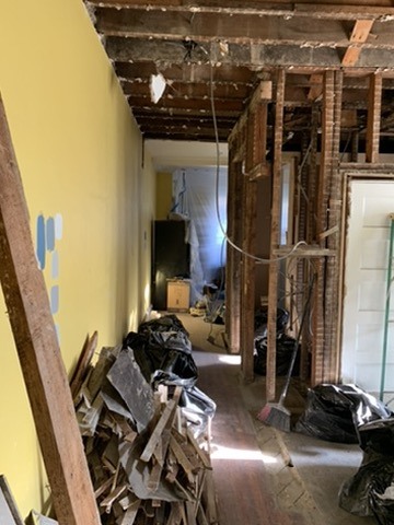 Interior renovation with exposed framing and an open passage