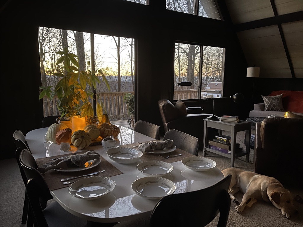 Faust’s table set with gourds in evening light, with Sidney resting nearby